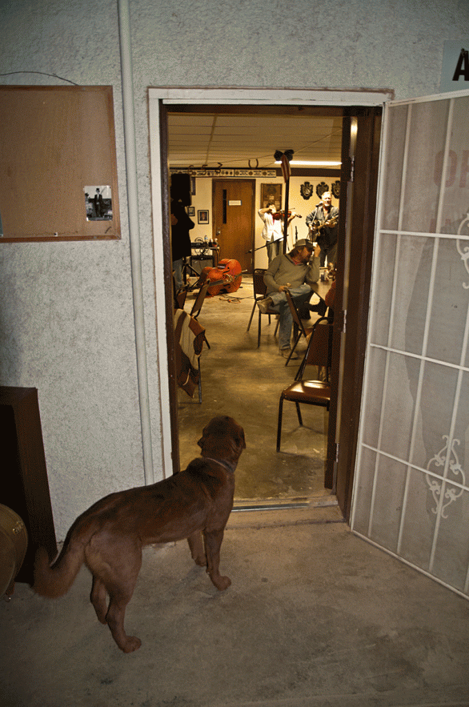 Jeff Haislip entertains with a song about alien sex while Radar, the dog, looks on.