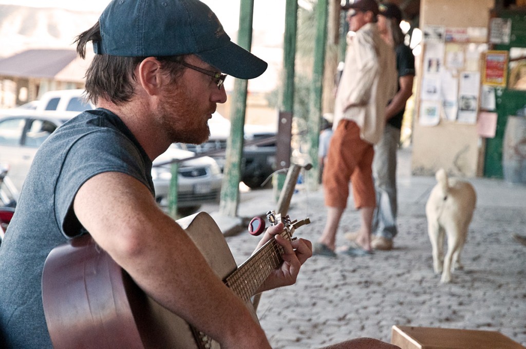 Chase on the porch playing guitar in Terlingua